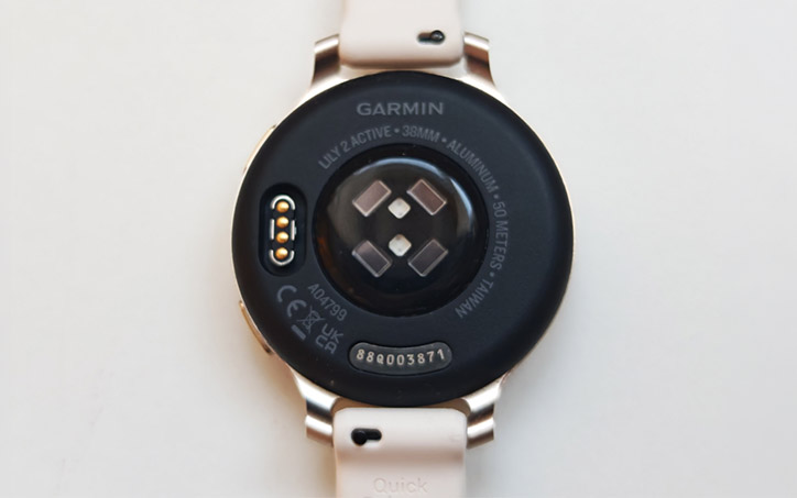 Garmin Lily 2 okosóra hátoldala érzékelőkkel és töltőcsatlakozóval fehér háttéren.