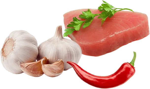 Két fokhagymafej, gerezd, egy piros chili, petrezselyemág és egy szelet nyers hús látható fehér alapon.