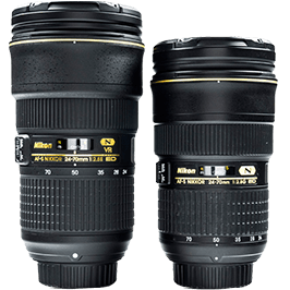 Két fekete Nikon fényképezőgép objektív látható, feliratokkal és arany díszítéssel, fehér háttér előtt.