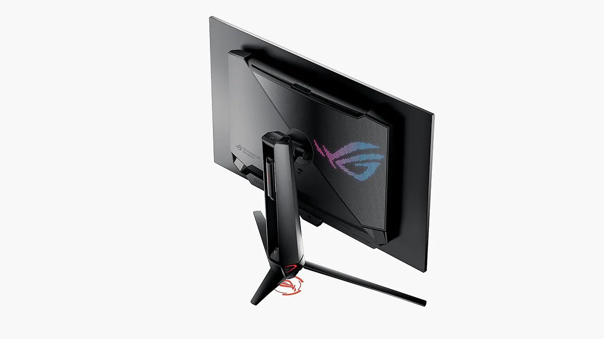 Der Asus ROG Swift OLED PG27UCDM von hinten mit farbig projiziertem ROG-Logo an der Unterseite des Standes und mit farbigen Bildpunkten an der Monitor-Rückseite.