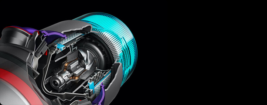 Nahaufnahme eines Staubsaugerkopfes mit freigelegter Mechanik vor einem schwarzen Hintergrund. Sichtbar sind blaue, graue, rote und violette Elemente.