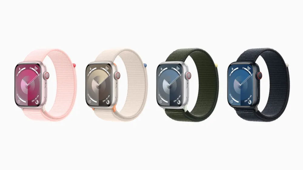 Vier Smartwatches in Reihe: rosa, beige, grün und schwarz, alle mit silbernem Gehäuse und farblich passenden Armbändern.