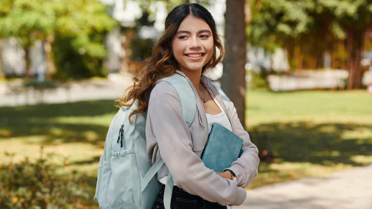 Eine Schülerin trägt einen Rucksack.