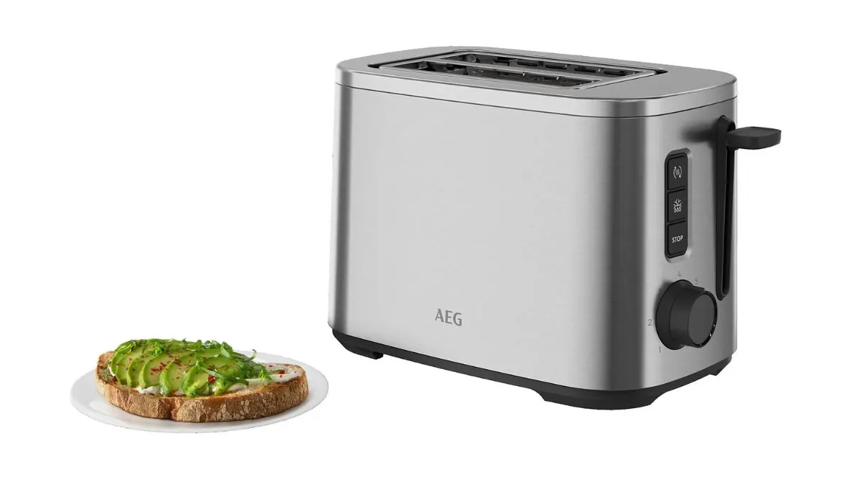 Der Toaster AEG Deli 5 T5-1-4ST und ein Brot mit Avocado auf einem Teller vor weißem Hintergrund.