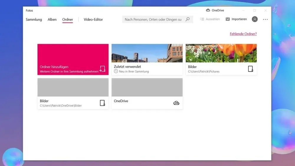 Ein Computerbildschirm zeigt das Fenster "Fotos" mit Optionen für Sammlung, Alben und Ordner, darunter Ordner hinzufügen und OneDrive.