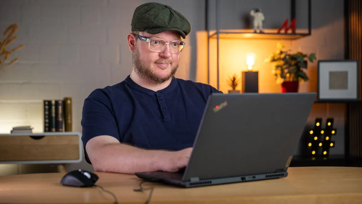 Andreas tippt auf einem Laptop.