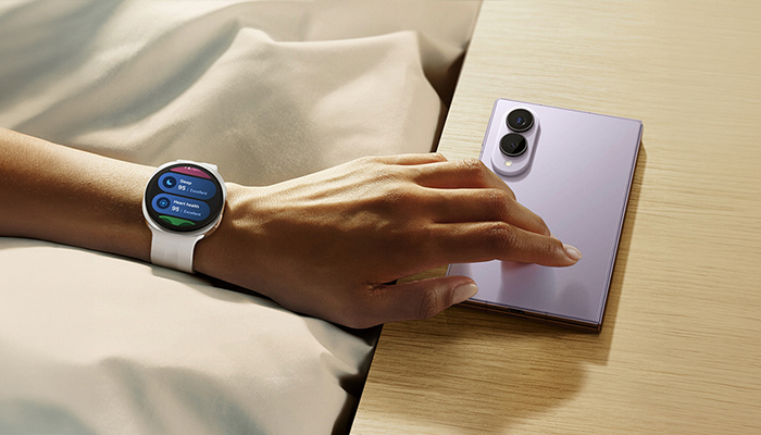 Samsung Galaxy Watch9 am Handgelenk neben einem Galaxy Smartphone. Nahtlose Vernetzung für Kommunikation und Fitness im Alltag. 