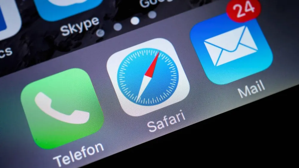 Nahaufnahme eines Smartphone-Bildschirms mit Icons für Telefon, Safari und Mail, sowie Skype und Google.