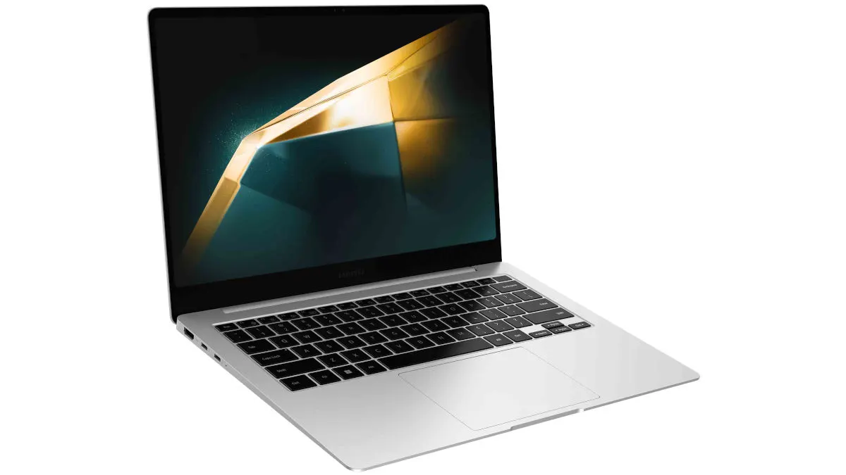 Ein geöffneter silberfarbener Laptop mit schwarzer Tastatur zeigt ein abstraktes, goldenes und dunkles Muster auf dem Bildschirm.