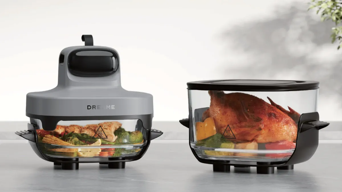 Die Dreame Tasti Heißluftfritteuse mit kleinem und großem Glasbehälter auf einer grauen Oberfläche.