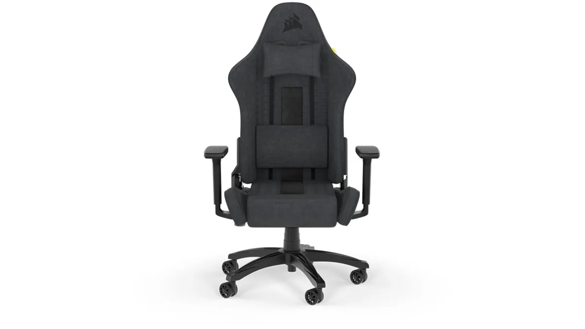 Ein dunkler Gaming-Stuhl mit Kopfstütze und Lordosenstütze steht auf einem schwarzen Fußkreuz mit Rollen.