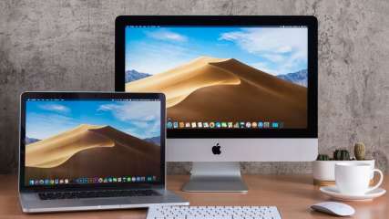 Macbook steht neben einem iMac Bildschirm