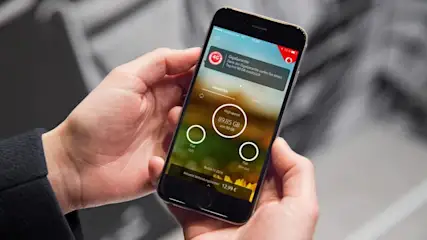 Eine Person hält ein Smartphone mit einer App, die Datenverbrauch anzeigt, in der Hand.