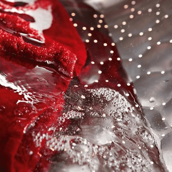 Innere der Trommel der MIELE WWD 660 WCS Waschmaschine mit rotem Handtuch und Wassertropfen