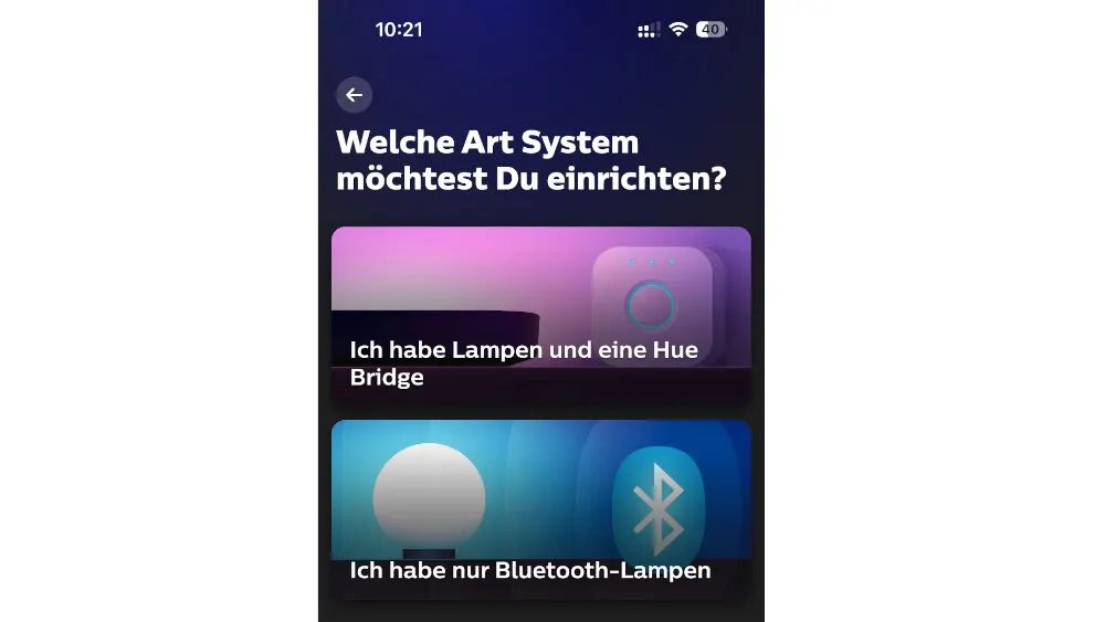Ein Smartphone-Display mit der Frage "Welche Art System möchtest Du einrichten?" und zwei Optionen: "Lampen und Hue Bridge" oder "nur Bluetooth-Lampen".