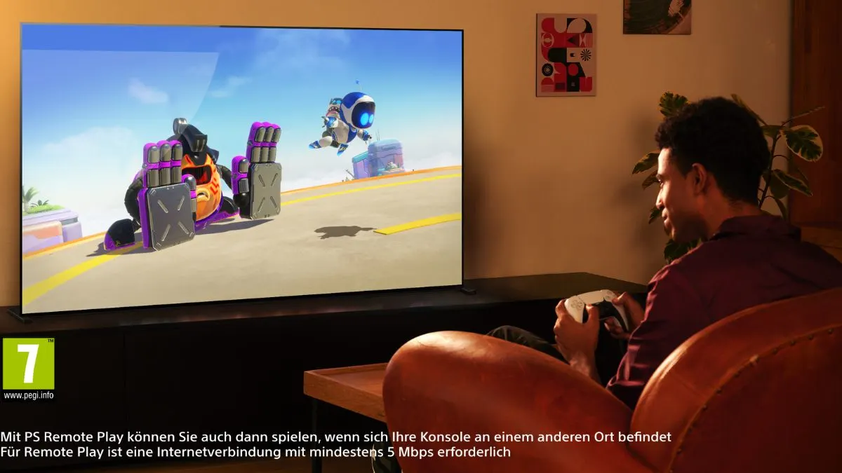 Ein Mann zockt mit einem PS5-Controller auf dem Fernseher Sony Bravia 8 II.