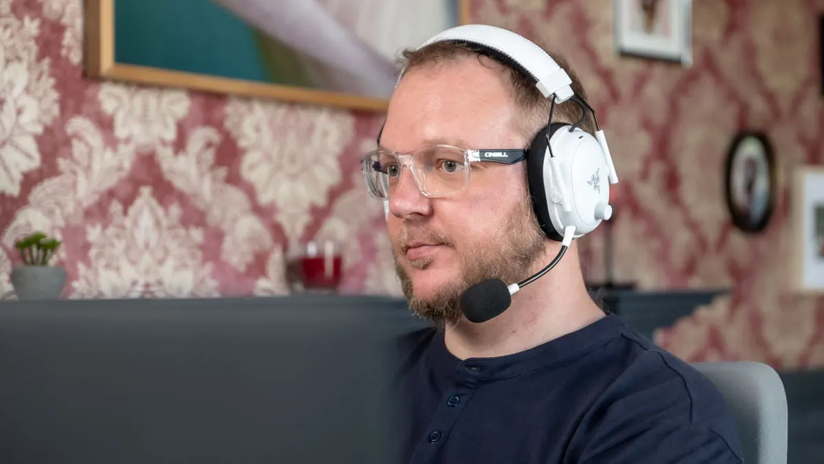 Andreas sitzt mit dem Razer BlackShark V3 Pro vor einem Monitor.