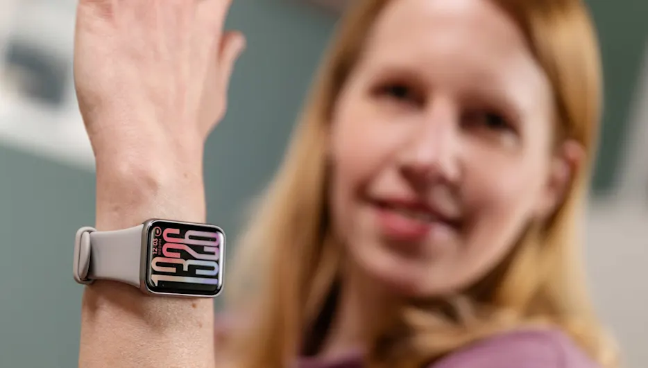 Franzi trägt das Xiaomi Smart Band 9 Pro am linken Handgelenk und hält den Arm hoch.