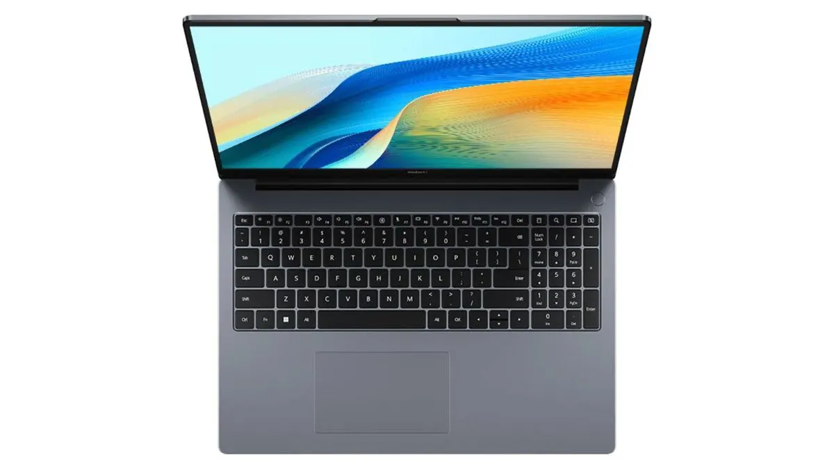 Ein geöffneter, grauer Laptop mit schwarzer Tastatur und Touchpad vor einem weißen Hintergrund. Der Bildschirm zeigt ein farbenfrohes Muster.