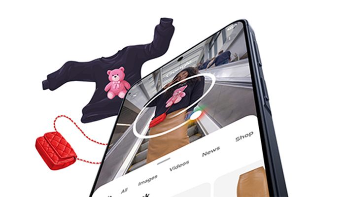 Stilisierte Darstellung der Circle to Search-Funktion, die ein auf dem Display eingekreisten Pullover via Google sucht. 