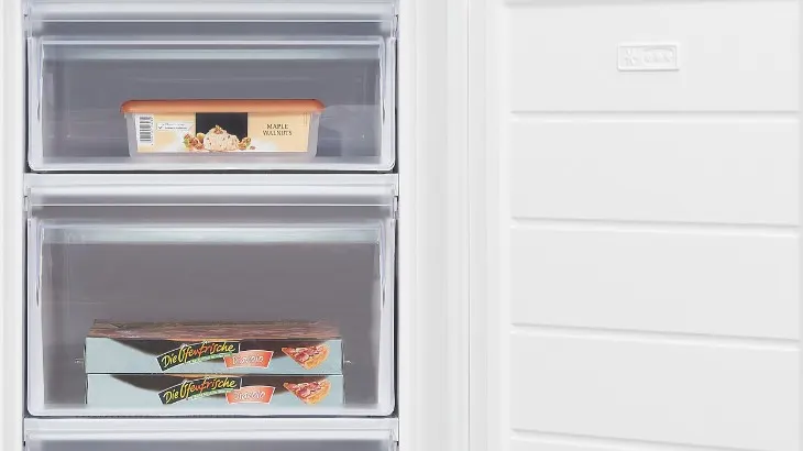 Ein offener, weißer Gefrierschrank mit zwei Schubladen. Die obere Schublade enthält Eis, die untere Tiefkühlpizza. Die Tür ist rechts.