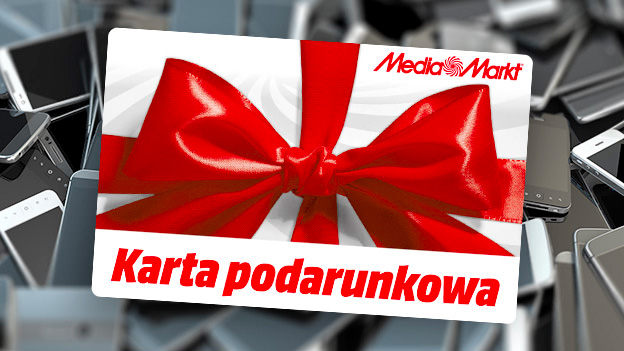 Karta podarunkowa Media Markt na tle stosu telefonów. Karta jest biała z czerwonym napisem i czerwoną kokardą.