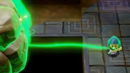 Gra wideo ukazuje zielony strumień energii łączący postać z kamiennym obiektem na tle kwadratowej podłogi.