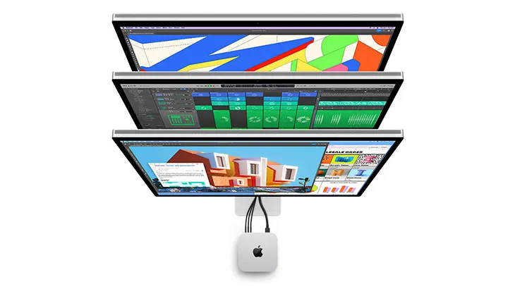 Trzy ekrany komputerowe ułożone jeden nad drugim, podłączone do małego, białego komputera z logo Apple. Ekrany wyświetlają różne obrazy.