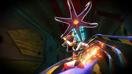 Na torze Shadow the Hedgehog, nad nim ciemna gwiazda z żółtym okiem. W tle metalowa konstrukcja.