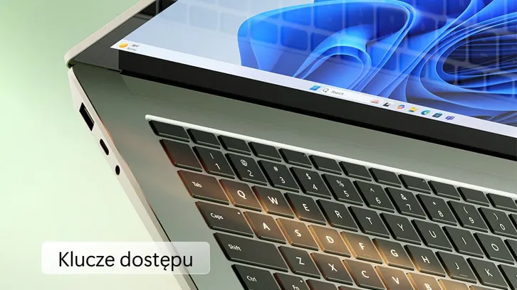 Laptop z czarną klawiaturą i ekranem pokazującym abstrakcyjny niebieski wzór na zielonym tle.