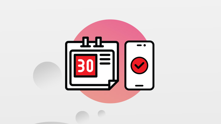 Kalendarz i telefon na różowym tle.