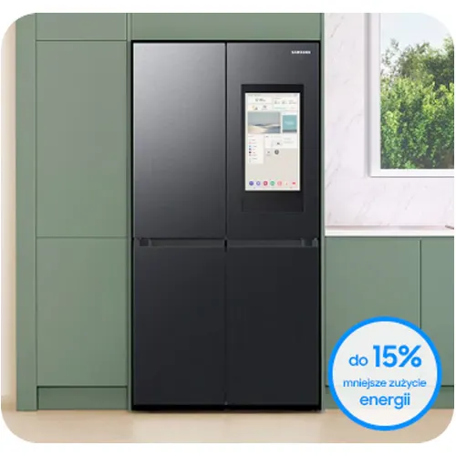 Czarna lodówka Samsung z ekranem dotykowym stoi obok zielonej szafki kuchennej, obok okno. Reklama: "do 15% mniejsze zużycie energii".