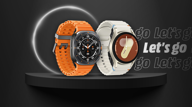 Dwa smartwatche: pomarańczowy z kwadratową tarczą i biały z okrągłą, na czarnym tle z napisem "Let's go".