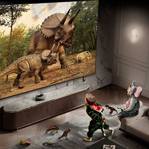 Dwójka dzieci oglądająca dinozaury w telewizji