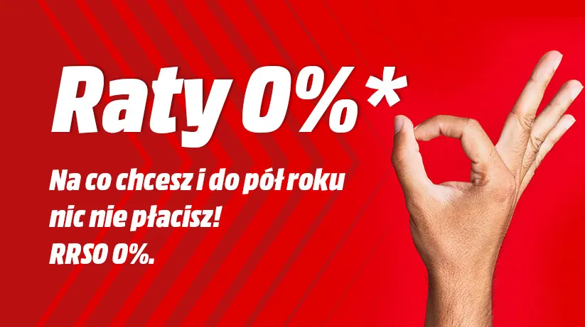 Czerwone tło z białym tekstem "Raty 0%*" i hasłem reklamowym. Prawa ręka pokazuje gest "OK".