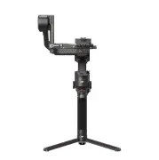 Czarny, elektroniczny stabilizator kamery z trzema nogami na białym tle.