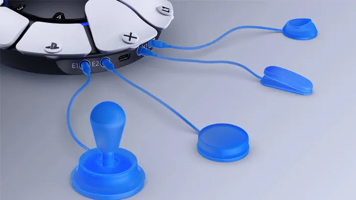 Część kontrolera z przyciskami i akcesoriami w kolorze niebieskim na jasnym tle.