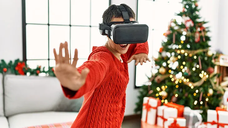 Postać mająca okulary vr i ćwicząca sztuki walki, w tle choinka.