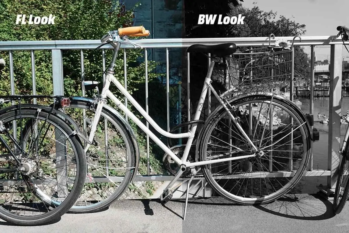 Bicicletta accanto a un ponte, metà sinistra con il Creative Look FL (Film), metà destra con il look BW (bianco e nero). 