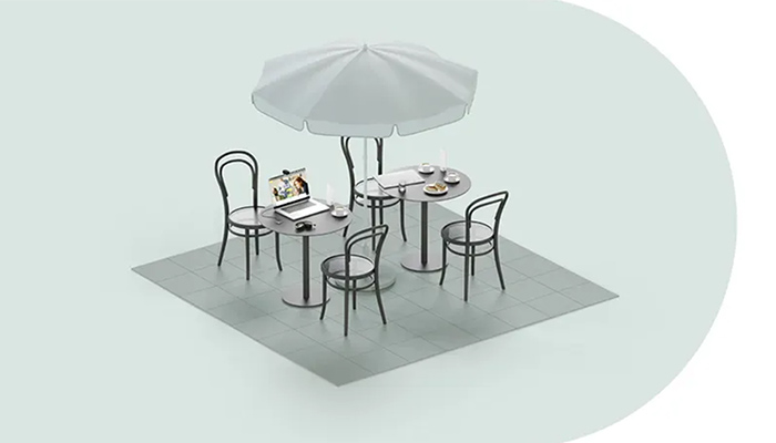 An einem Bistrotisch liegen alle notwendigen Arbeitsgeräte wie Notebook, Smartphone u.v.m.