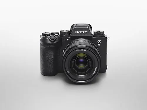 Una fotocamera Sony nera con obiettivo � centrata su uno sfondo bianco sfumato.