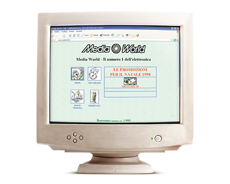 Vecchio monitor del computer che mostra il sito web di MediaWorld con promozioni natalizie del 1999.