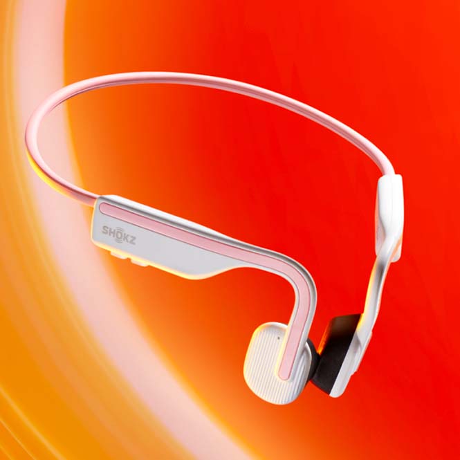 Cuffie bianche e rosa ad arco su sfondo sfumato arancione e rosso. L'archetto poggia sulla parte superiore, mentre i cuscinetti sono in basso.