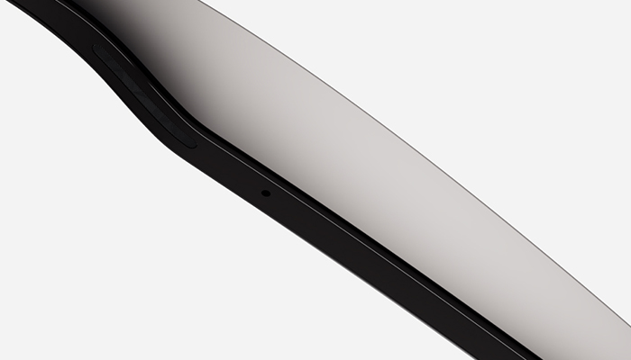 Vista angolata di un dispositivo con cornice nera e schermo grigio chiaro su sfondo bianco.