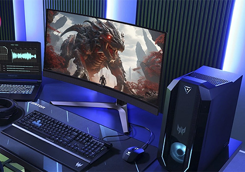Scrivania da gaming con PC, monitor con immagine di drago, tastiera, mouse e laptop aperto. Illuminazione blu.