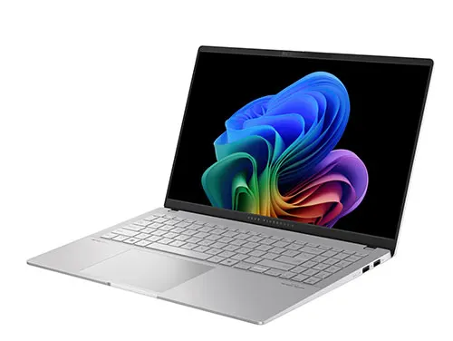 Un laptop aperto mostra uno schermo nero con una grafica astratta colorata. La tastiera e il touchpad sono visibili.