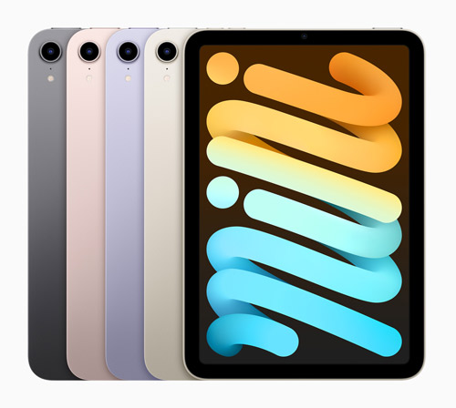 Quattro iPad Mini di vari colori affiancati. Lo schermo di uno mostra un motivo a spirale arancione e blu su sfondo marrone.