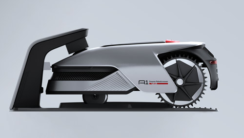 Tosaerba robotico grigio e nero su fondo grigio chiaro. Ha ruote dentate e un design aerodinamico.