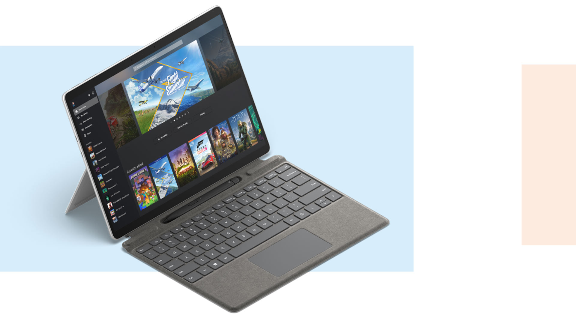 Tablet grigio con tastiera collegata, appoggiato su supporto, schermo acceso con immagini di videogiochi.