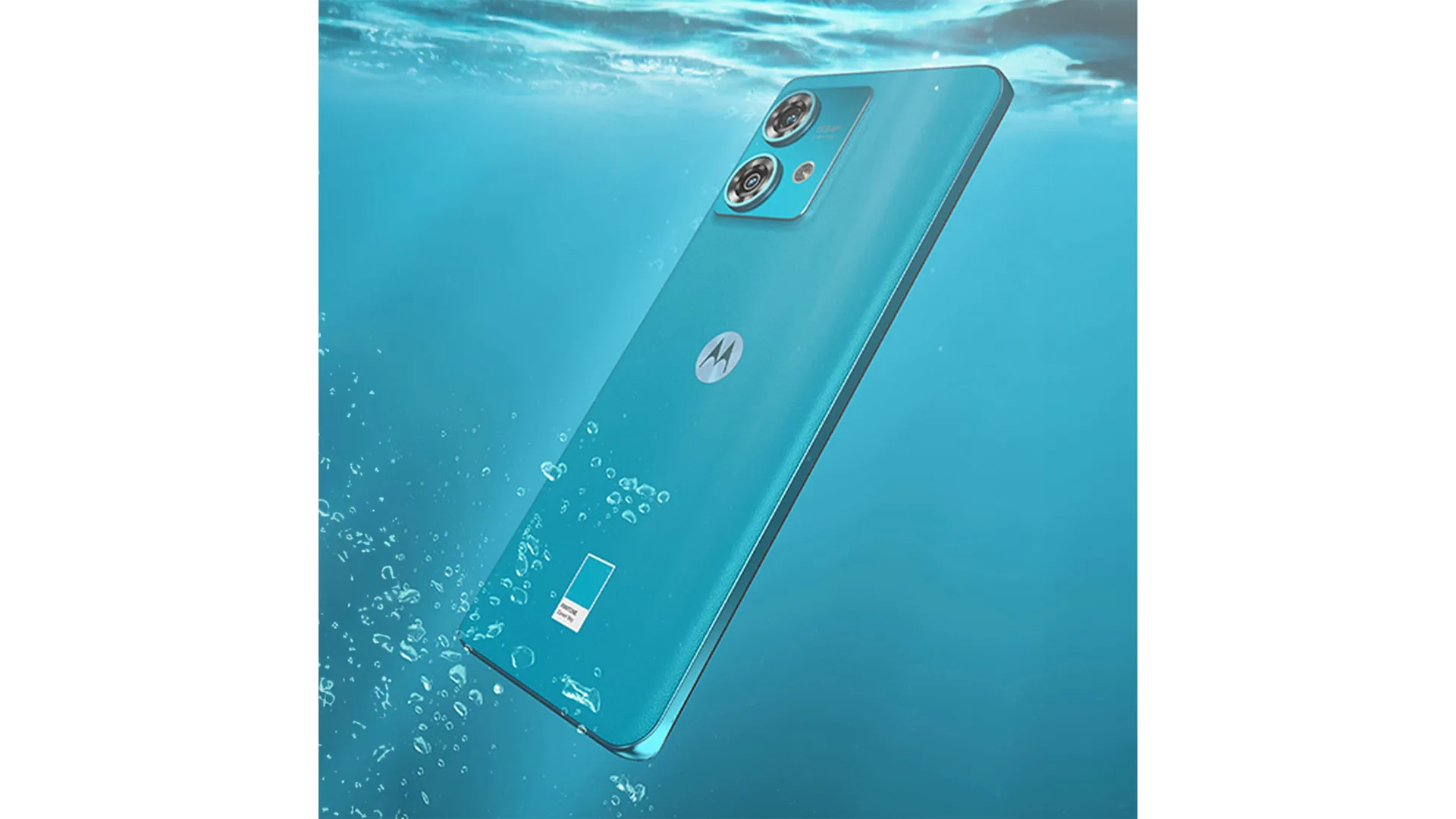Un telefono turchese con due fotocamere � immerso nell'acqua, con il logo Motorola visibile sul retro.